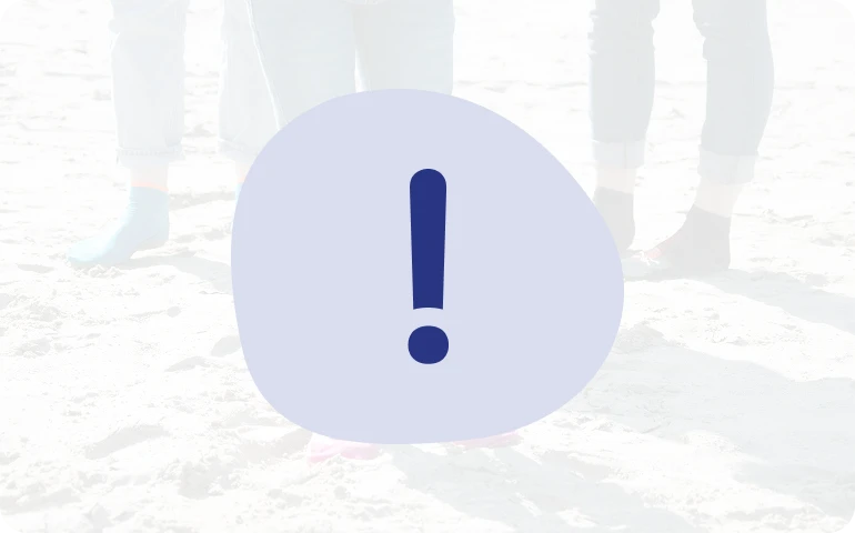Dunkelblaues Ausrufezeichen auf hellblauem Untergrund. Im Hintergrund sind drei Personen mit Beachie® Socken am Strand zu sehen